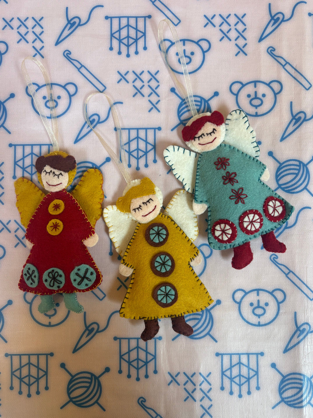 Three little Christmas felt angels with a Scandinavian feel using embroidery sewing techniques.