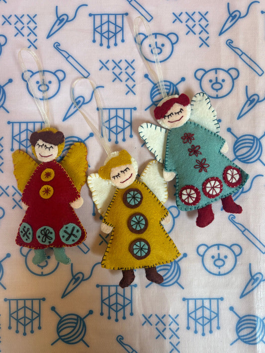 Three little Christmas felt angels with a Scandinavian feel using embroidery sewing techniques.