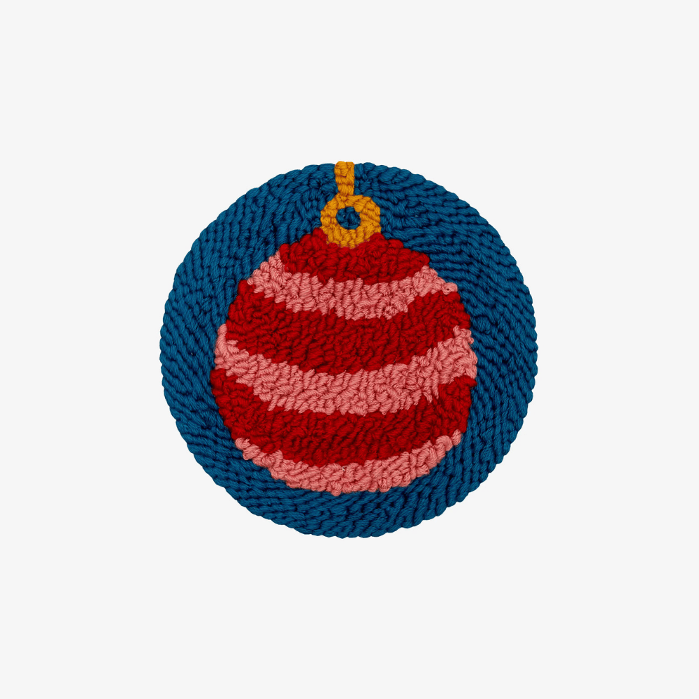 Knitted ornament with red and pink stripes on a blue background