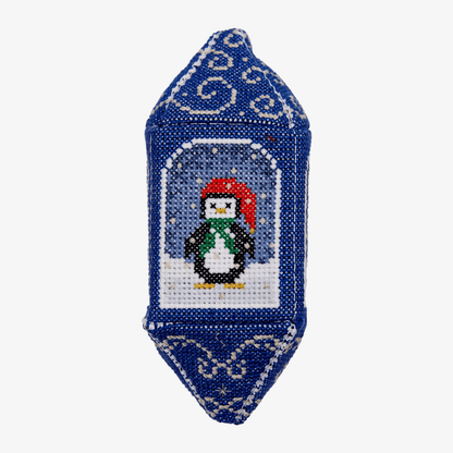Decorative ornament with a penguin design on a blue background