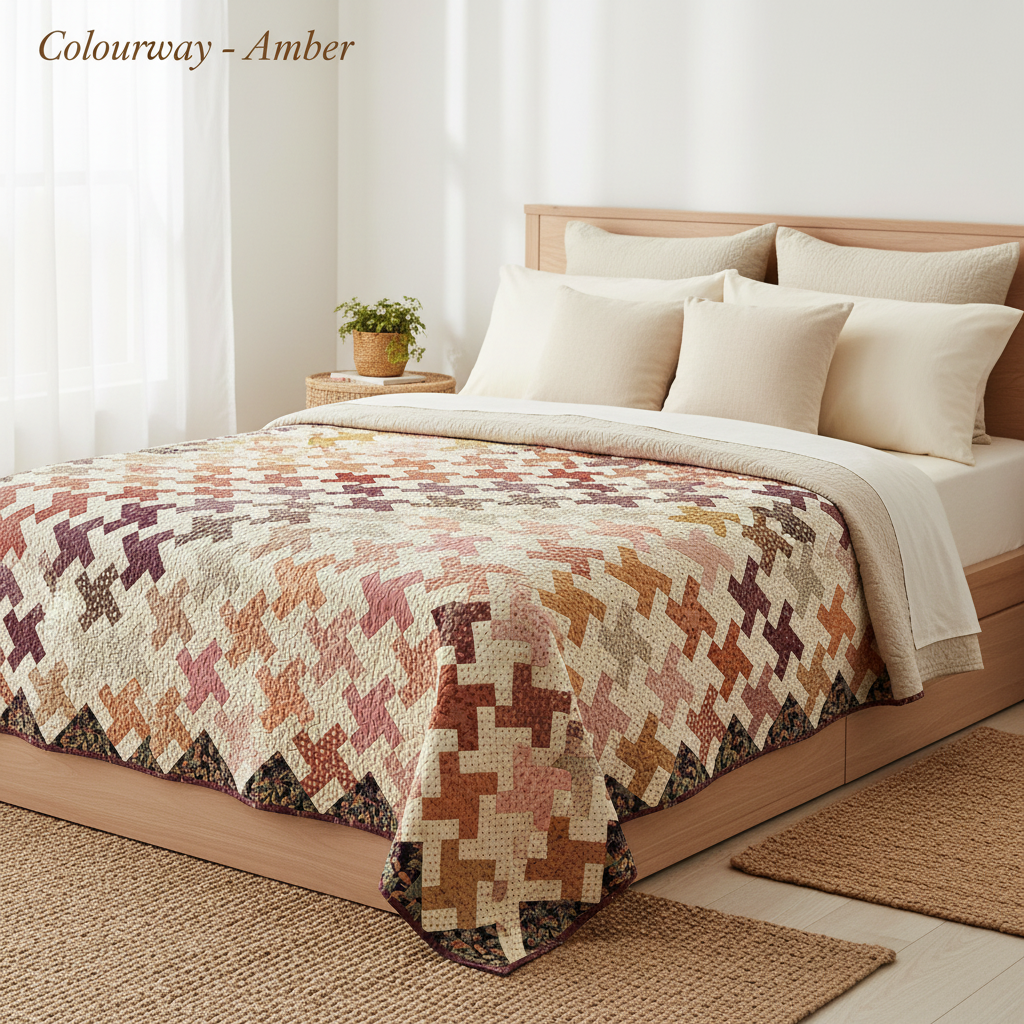 Whirl Secret Stash Amber colourway quilt laid on a bed with Colourway - Amber text