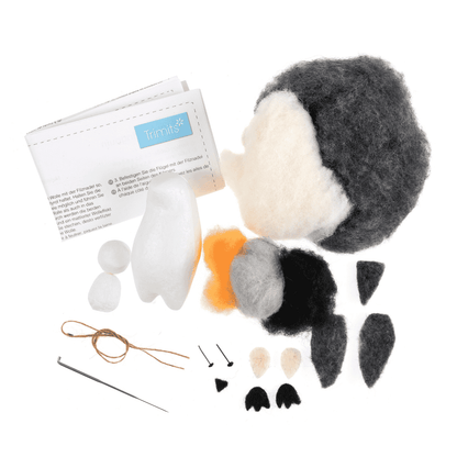 Felt animal craft kit with pieces and instructions on a white background